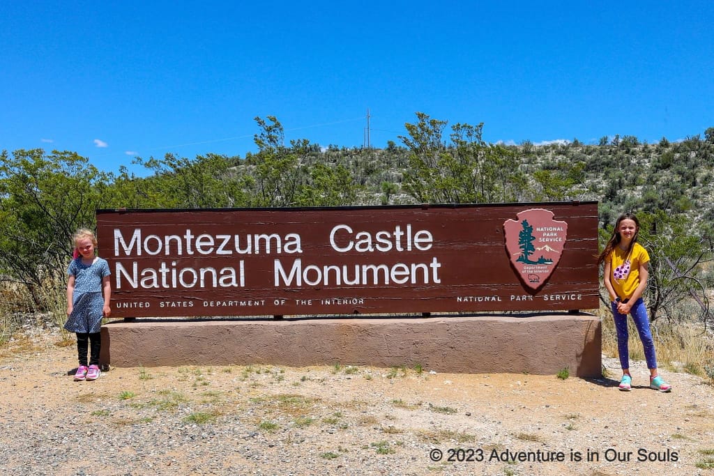 Spider Monkey and Buttercup at Montezuma Castle NM sign